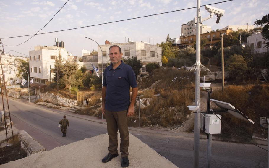Yaser Abu Markhyah, 49, is seen on the roof of his home in Hebron with Israeli army surveillance cameras nearby. "We no longer feel comfortable socializing because cameras are always filming us," he said.