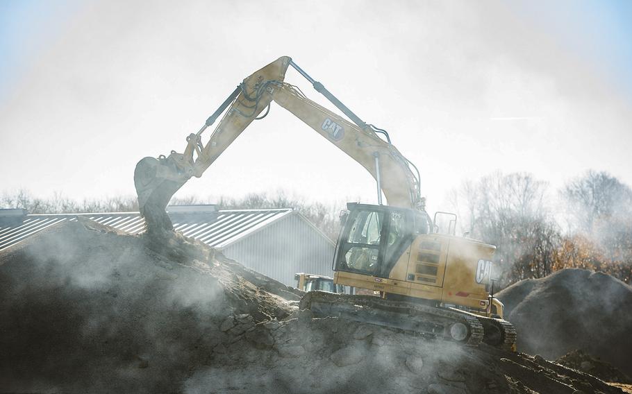 A worker uses an excavator Nov. 21, 2021, to prep a gravel pile at Wright-Patterson Air Force Base, Ohio. The 450-foot trench being dug is part of an Area B construction project designed to help remove substances previously used in firefighting from groundwater. 