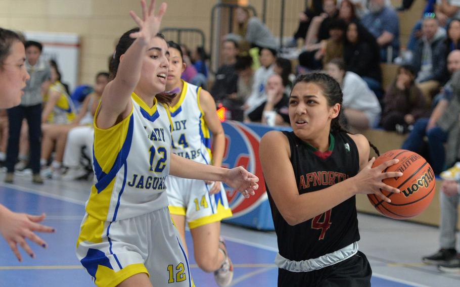 AFNORTH’s Selah Skariah drives to the basket against Sigonella’s Fabiola Mercado-Rodriguez in the Division III championship game at the DODEA-Europe basketball finals in Ramstein, Germany, Feb. 18, 2023. Sigonella took the division title with a 36-25 win.