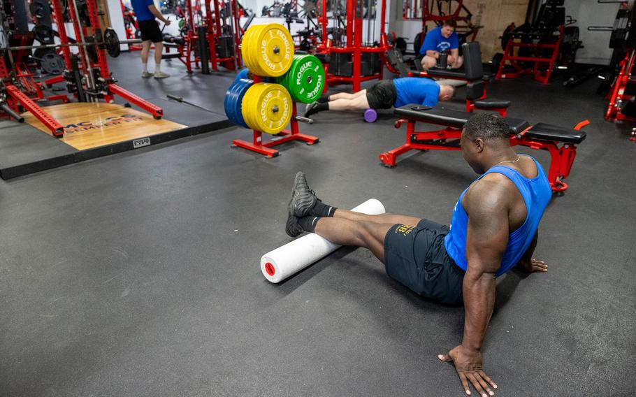 A Marine works out in a gym