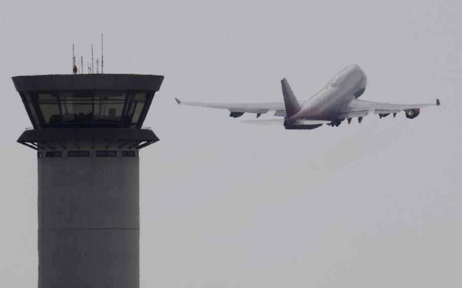 An aircraft takes off from Larnaca airport past the control tower, at the southern coastal city of Larnaca, Cyprus, Oct. 7, 2017. A flight safety organization is warning that a Turkish drone base in ethnically divided Cyprus could increase safety risks for thousands of commercial flights that cross the airspace around the eastern Mediterranean island.