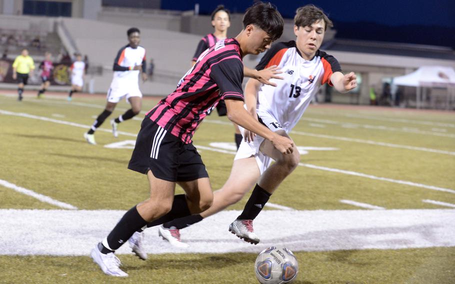 Kadena's Skylar Dluzeski and Nile C. Kinnick's Jacob Juday battle for the ball during Friday's DODEA interdistrict boys socceer match. The Panthers prevailed 2-0 in a rematch of last spring's Far East Division I final, won by the Red Devils at Kinnick 3-2.