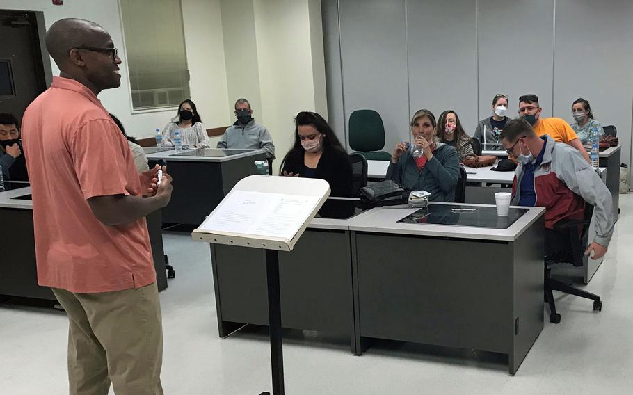 Army Chaplain (Maj.) Cornelius Muasa oversees the Wellness on Wednesday personal growth curriculum with help from volunteers at Torii Station Chapel on Okinawa.