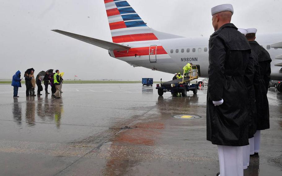 The remains of Seaman First Class Wilbur F. Newton, who was killed December 7, 1941, while stationed on the USS Oklahoma at Pearl Harbor, were returned to Missouri aboard a flight Tuesday afternoon at KCI. Family members gathered as rain and heavy winds blew across the tarmac.