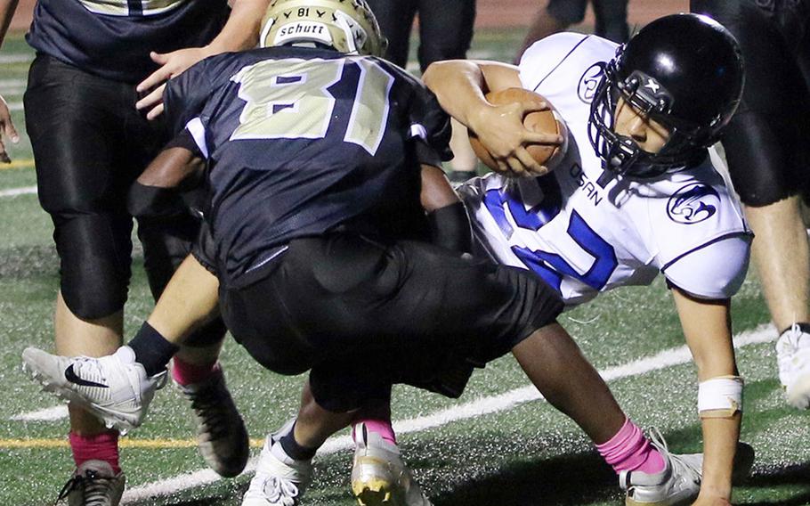 Osan's Eddie Kim dives through the tacke of Humphreys Black's Tyler Wilks into the end zone for a two-point conversion.