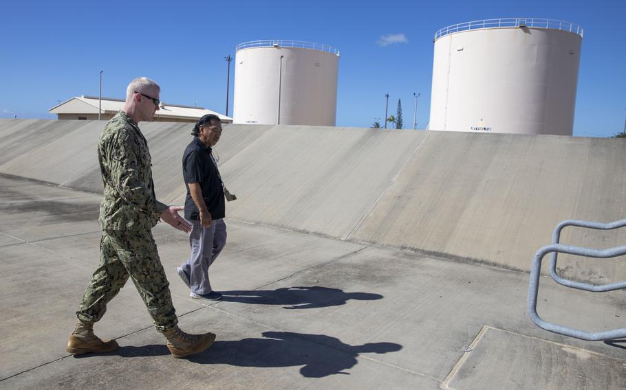 U.S. Navy Rear Adm. John Wade, Joint Task Force-Red Hill commander, and Brian Inouye, the Naval Supply Systems Command Fleet Logistics Center Pearl Harbor Fuel Manager, tour the fuel tanks at Joint Base Pearl Harbor-Hickam Fuel Farms, Hawaii, Oct. 25, 2022. 