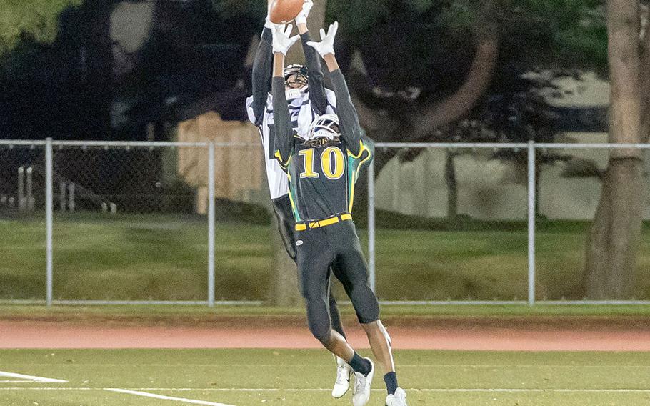 Zama's Pierce Ingram outleaps Edgren's Messai Cain for the football.