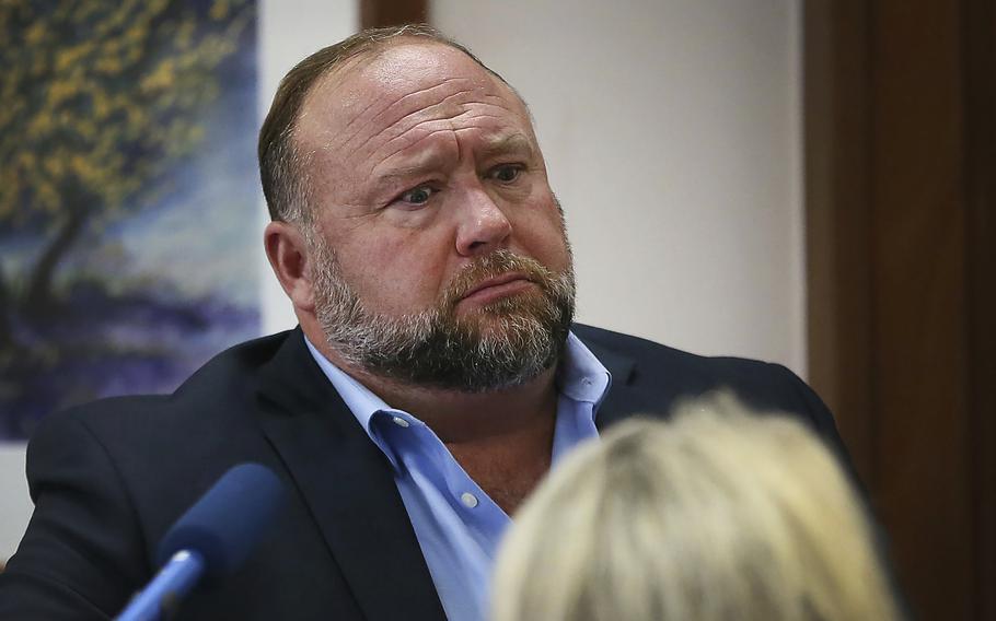 Conspiracy theorist Alex Jones attempts to answer questions about his emails during trial at the Travis County Courthouse in Austin.
