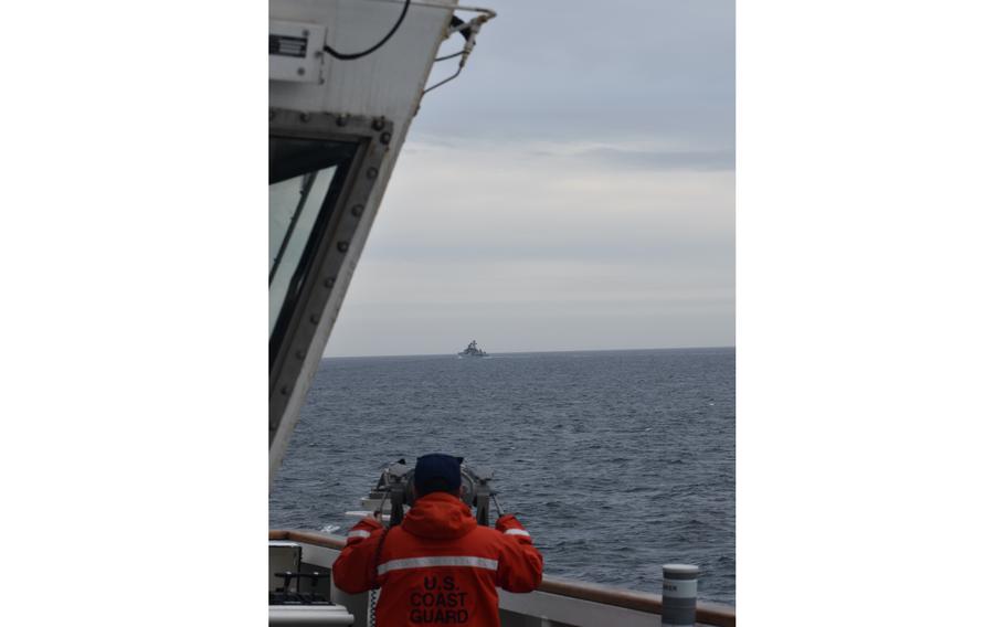 A Coast Guard Cutter Kimball crewmember observing a foreign vessel in the Bering Sea, September 19, 2022.