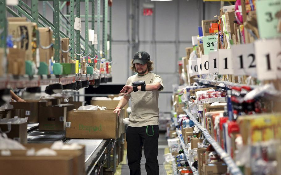 A Peapod worker prepares items for packaging and delivery at one of its online distribution facilities in Lake Zurich, Ill., on June 19, 2012. Starting Saturday, Jan. 1, 2022, food labels at grocery stores will follow new rules for classifying genetically modified items.