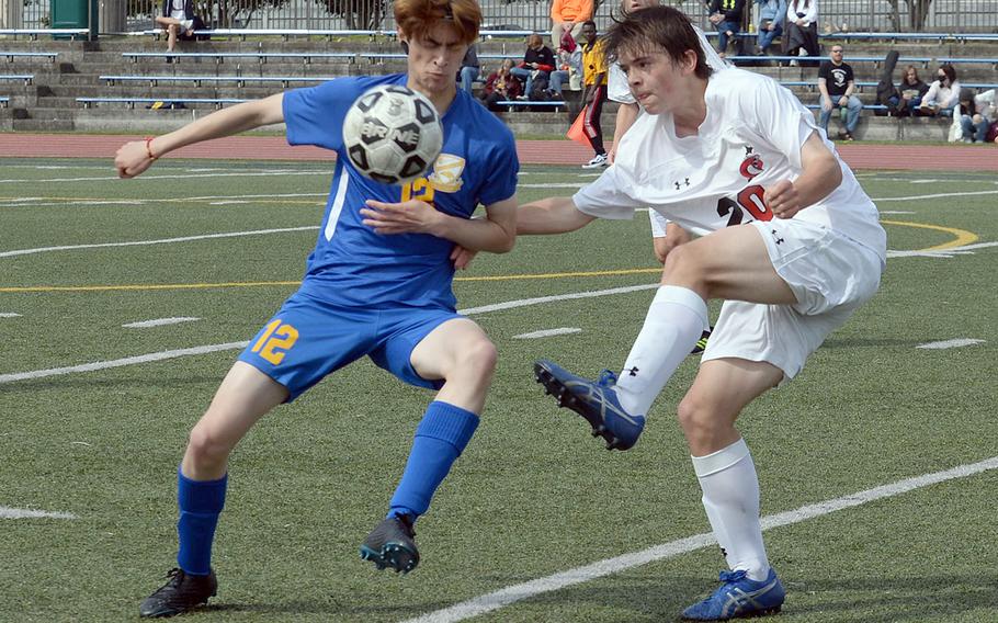 E.J. King's Nathan Reed boots the ball past Yokota's Kai Howell during Thursday's All-DODEA-Japan soccer tournament. The Panthers won 8-0.