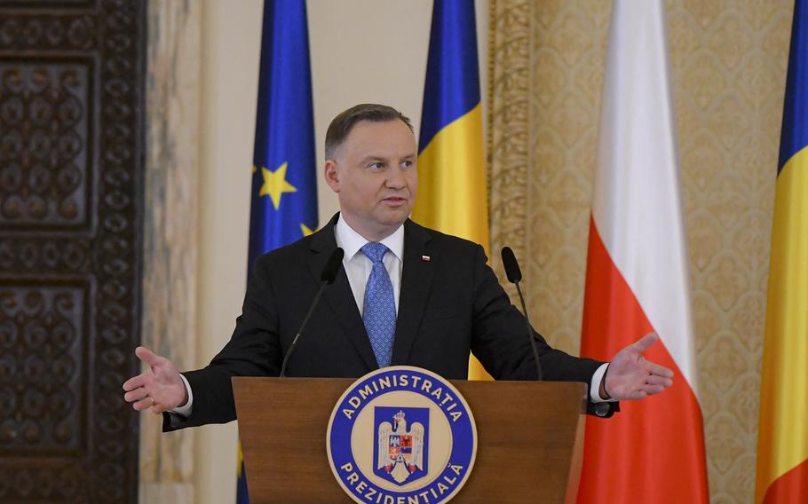 Poland’s President Andrzej Duda gestures during press statements with Romania’s President Klaus Iohannis at the Presidential Palace in Bucharest, Romania, Tuesday, March 22, 2022. 