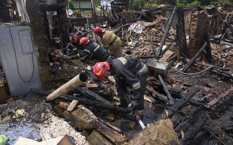 Rescue workers dig through rubble.