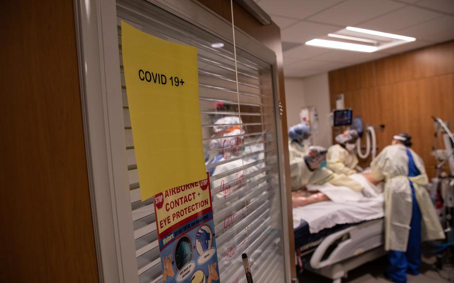 A "prone team," wearing personal protective equipment, prepares to turn a COVID-19 patient onto his stomach in a Stamford Hospital intensive care unit on April 24, 2020, in Stamford, Connecticut. 
