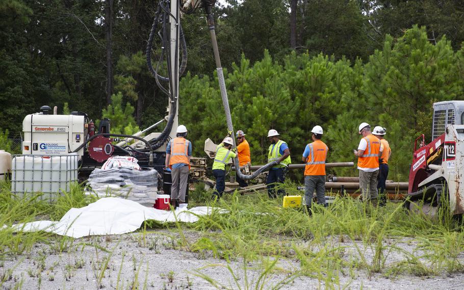 Navy contractors use a sonic drill to install a groundwater monitoring well to gather soil and water samples to be tested for per- and polyfluoroalkyl substances, or PFAS, on Marine Corps Base Camp Lejeune, N.C., in August 2020. PFAS are man-made chemicals commonly used for clothing, food packaging and carpeting and have the potential to be toxic.  