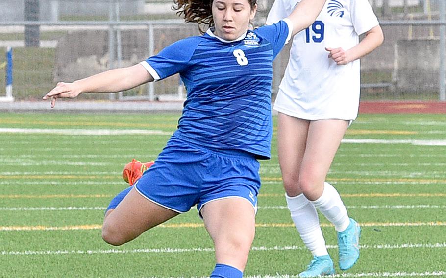 Ramstein's Julia Adkins prepares to launch a shot from distance during Saturday morning's match against Wiesbaden at Ramstein High School on Ramstein Air Base, Germany. Trailing the play is the Warrior midfielder Bridget Pidgeon.