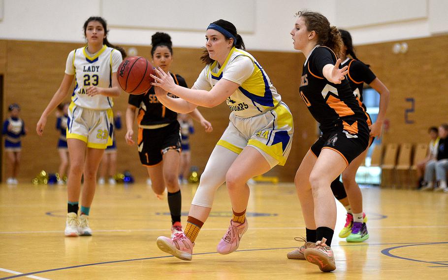 Sigonella senior Laney Reardon passes the ball out to the wing while Spangdahlem senior Talyssa Link defends during pool-play action on Feb. 15, 2024, at Wiesbaden Middle School in Wiesbaden, Germany.