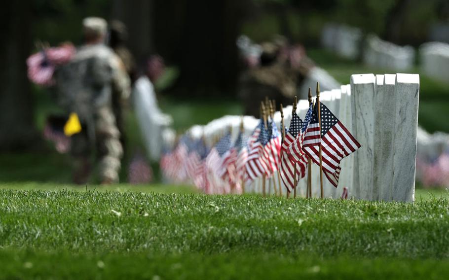 U.S. flags are placed in front of every grave site ahead of Memorial Day weekend in Arlington National Cemetery on May 21, 2020, in Arlington, Virginia. Army Pfc. David Owens, killed in action during World War II, will be buried at Arlington National Cemetery. 