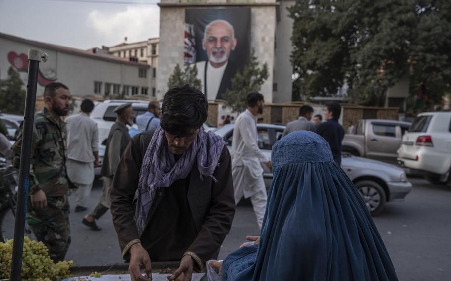 A portrait of Afghan President Ashraf Ghani in central Kabul on Aug. 14, 2021, a day before the Taliban takeover. Five British men held by the Taliban have been released, the United Kingdom’s Foreign Office said in a statement Monday, June 20, 2022.