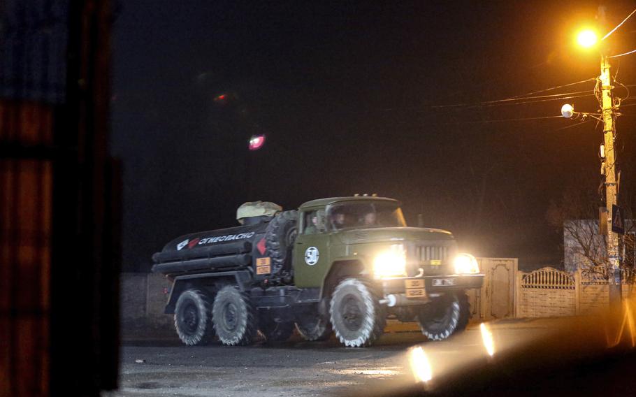 A military truck drives down a street outside Donetsk, the territory controlled by pro-Russian militants, eastern Ukraine, late Tuesday, Feb. 22, 2022. Europe braced for further confrontation Wednesday, Feb. 23, 2022, after tensions over Ukraine escalated dramatically when Russian President Vladimir Putin got the OK to use military force outside his country and the West responded with sanctions. 