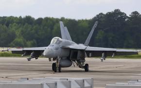 A Navy fighter jet taxis along the flight line.