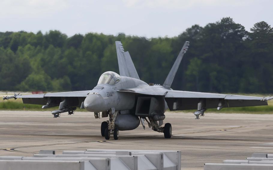 A Navy fighter jet taxis along the flight line.