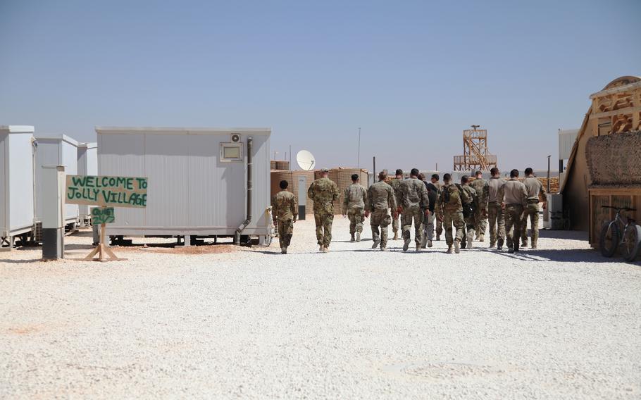 Military personnel file in for a briefing on a part of the base that houses U.S. Special Forces at the al-Tanf garrison in Syria on June 21, 2022.