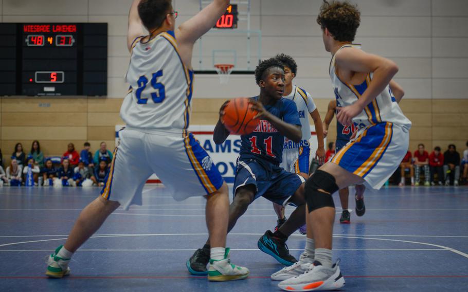Lakenheath’s David Kumi-Baah navigates through a crowd of Wiesbaden defenders at the DODEA European Division I basketball championships Feb. 16, 2023, at Ramstein Air Base, Germany. Wiesbaden beat Lakenheath  50-31 on Thursday.