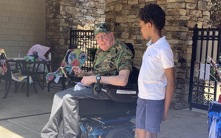 Harrison Johnson chats with a veteran. Over the past two years, the 11-year-old has raised more than $92,000 for Pacific Historic Parks. 