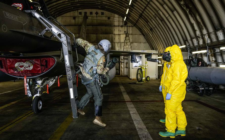 Staff Sgts. Jackson Riddle and Michael Tobat, aircraft maintainers with the 480th Fighter Generation Squadron, receive Airman 1st Class Eric Decker, a bioenvironmental engineering technician with the 52nd Operational Medical Readiness Squadron, during exercise Radiant Falcon at Spangdahlem Air Base, Germany. on April 24, 2024.