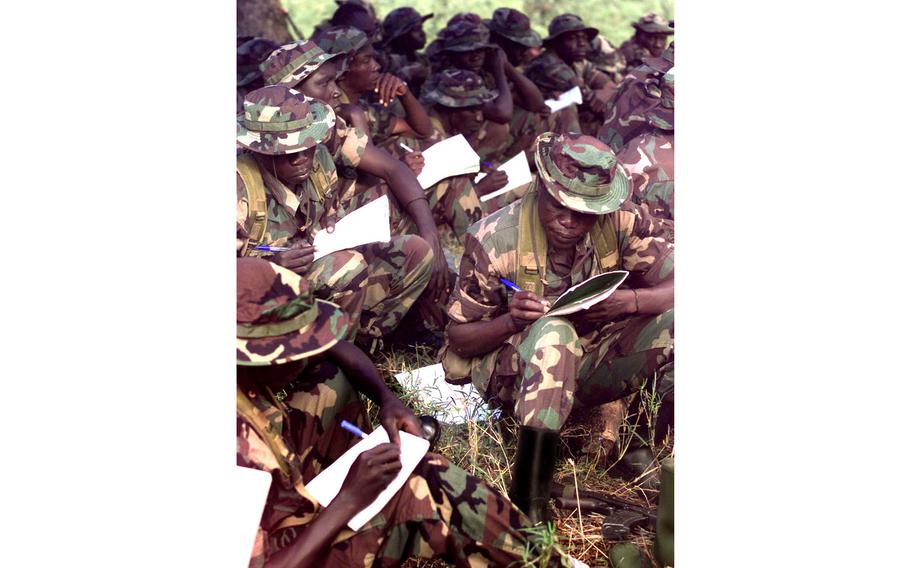 Ugandan soldiers take notes as U.S. Green Berets teach them peacekeeping skills, in Kabamba, Uganda, Aug. 24, 1997. Sixty U.S. troops are spending two months teaching peacekeeping skills to Ugandan and Senegalese troops.