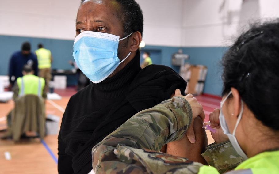 Enrique John, an employee at Kaiserslautern High School in Germany, receives the first dose of the Moderna COVID-19 vaccine at Ramstein Air Base in January 2021.  With less than three weeks to go until the deadline for all DOD civilians to be vaccinated, nearly 25% of DODEAs workforce has yet to provide proof or file for an exemption, agency officials said this week. 