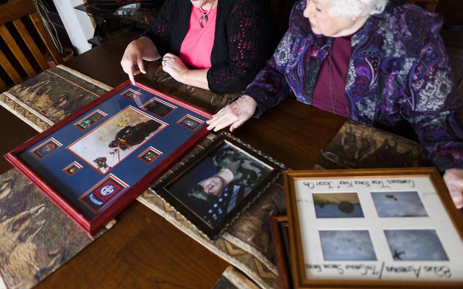 Scott Merryman’s mother, Terry Bryant, 61, and his grandmother Jeanne Irvine, 84, look over photos. Over the years, both tried to reassure Merryman and ease his anxieties. 