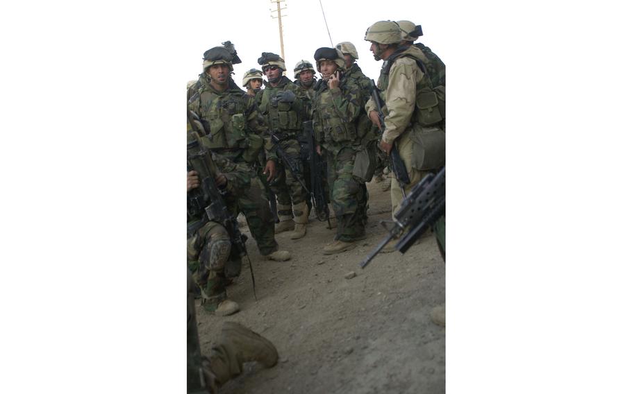 Marine Capt. Ted Handler reassesses his platoon's approach after faulty intelligence caused his platoon to hit the wrong building during the raid at Al Fahr, Iraq. 
