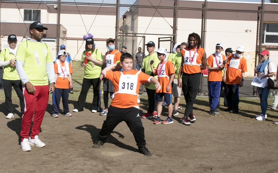 Jaden Beady, of Yokosuka Middle School at Yokosuka Naval Base, competes in the softball throw at Yokota Air Base, Japan, Saturday, Nov. 4, 2023. The event was part of the 44th Kanto Plains Special Olympics.