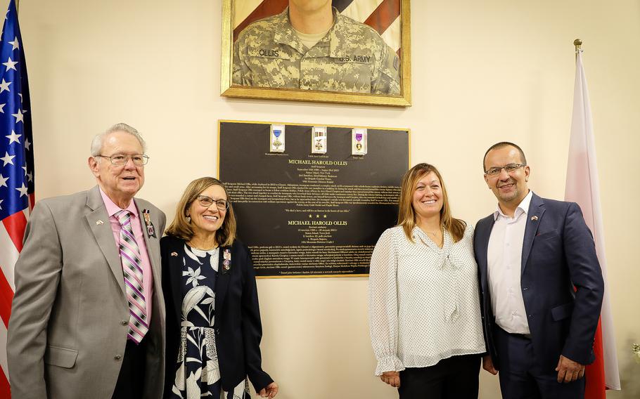 U.S Army Staff Sgt. Michael Ollis’ parents, Robert and Linda Ollis, sister Kelly Manzolillo and the Polish soldier he saved, Lt. Karol Cierpika, gathered at Camp Kosciuszko, Poland, on Oct. 27, 2023. The dining facility at the U.S. Army base in Poznan was named the Staff Sgt. Michael Harold Ollis Warrior Grill.