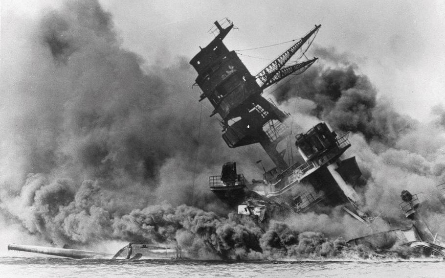 Smoke rises from the battleship USS Arizona as it sinks during the Japanese attack on Pearl Harbor, Hawaii, Dec. 7, 1941. 