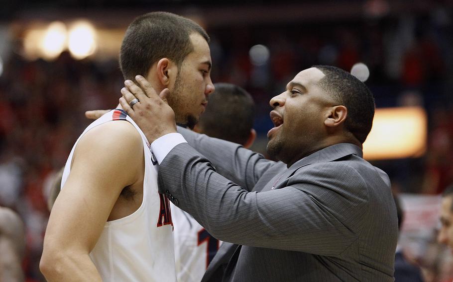Assistant coach Book Richardson of the Arizona Wildcats talks to guard Gabe York (1) of the Wildcats during a time-out of a college basketball game against the Oregon Ducks at McKale Center in Tucson, Arizona, in 2014.