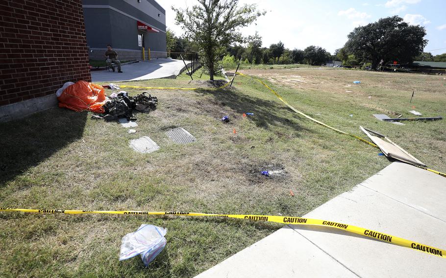 A parachute and other items remain outside an Ole Donut where one pilot landed after ejecting from a military training jet before it crashed Sept. 19, 2021, in Lake Worth, Texas.