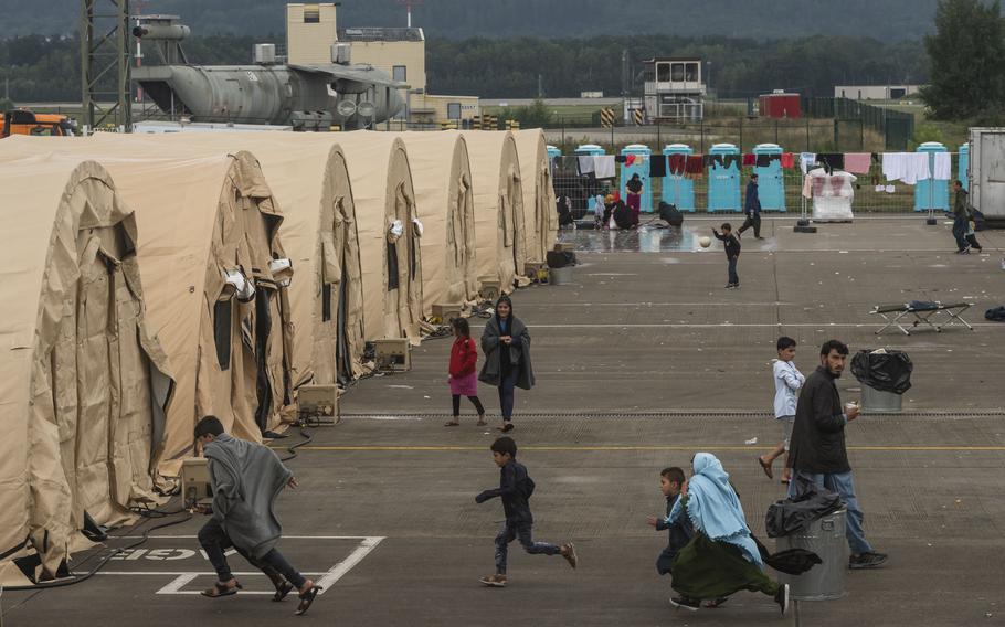 People moving outside tents.
