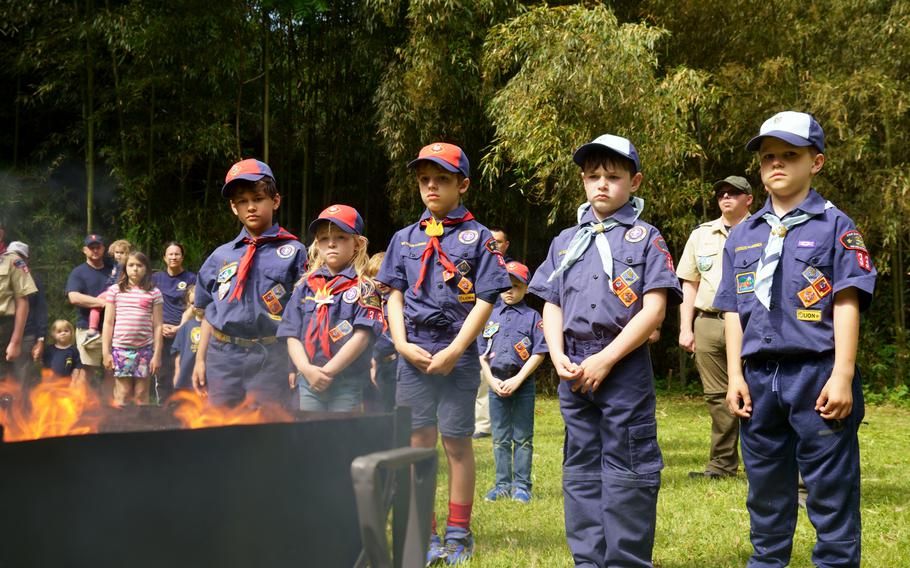 Cub Scouts with Yokosuka Pack 33 stand at attention during a flag retirement ceremony at Ikego West Valley Campground near Yokosuka Naval Base, Japan, May 6, 2023.