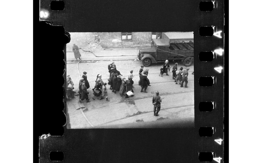 This handout negative dated April 20, 1943, and taken by Polish firefighter Zbigniew Leszek Grzywaczewski shows Jewish people being evacuated from the Ghetto to Umschlagplatz during the uprising of the Warsaw ghetto in 1943, Poland. On Wednesday, Jan. 18, 2023, Warsaw’s Jewish history museum presented a group of photographs taken in secret during the Warsaw Ghetto Uprising of 1943, some of which have never been seen before, that were recently discovered in a family collection. 