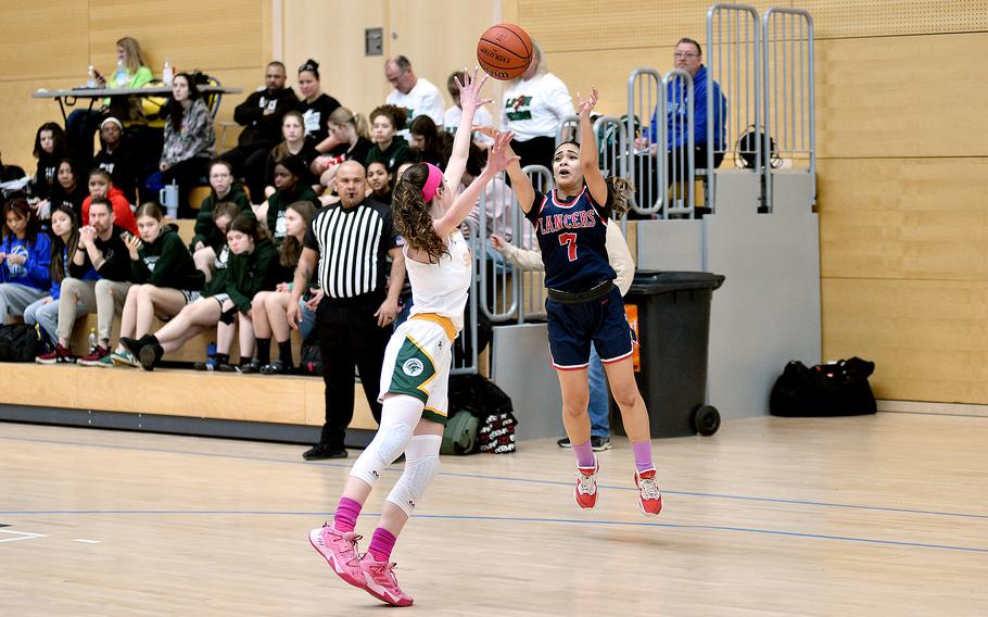 Lakenheath junior Solymar Brown shoots over SHAPE senior Jessica Moon during pool-play action of the DODEA European basketball championships on Feb.14, 2024, at the Wiesbaden Sports and Fitness Center on Clay Kaserne in Wiesbaden, Germany.