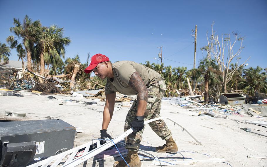 Members of the 202nd Red Horse Squadron clear roads in Fort Myers Beach, Florida, in response to Hurricane Ian on Friday, Sept. 30, 2022.