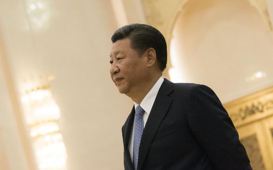 Chinese President Xi Jinping walks through the Great Hall of the People on Beijing's Tiananmen Square, Aug. 17, 2017.