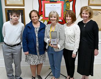 The daughters of Retired U.S. Marine Corps Col. Lou Schott, from left, Lois Beglan, Debora Hinds, Laurie Tyler, Eileen Yaeger and Patti Turner, pose with their father’s Silver Star medal at the conclusion of a ceremony honoring Schott, 102, on May 18, at Veterans of Foreign Wars Post 7472 in Ellicott City, Md.