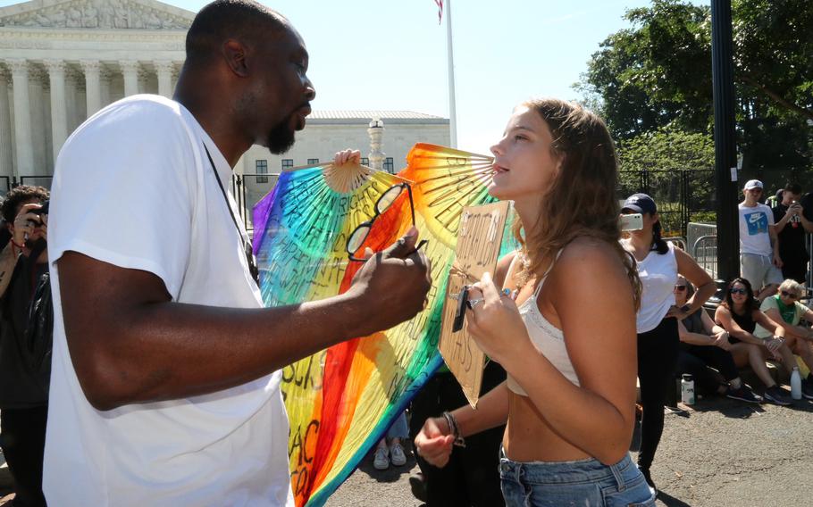 Jonathan Thomas, a supporter of the Supreme Court decision overturning Roe v. Wade, argues with pro-choice protester Juliette Dueffert in front of the court Saturday morning, June 25, 2022.