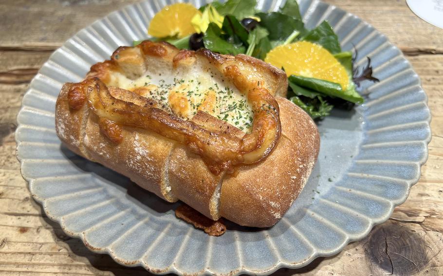 The eggs-and-cheese on bread from Aoyama Flower Market Tea House in Tokyo comes with a side salad and is crowned with fresh fruit.