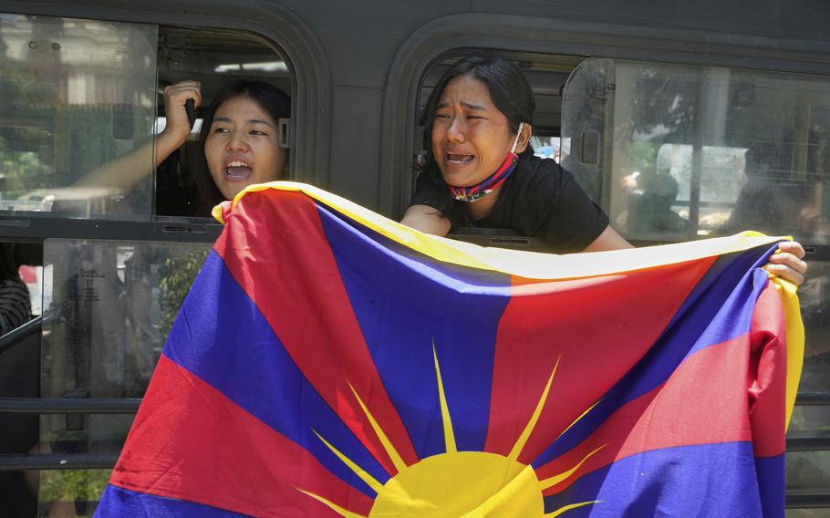 Tibetans protesting visit of Chinese Foreign Minister Wang Yi while holding the Tibetan Flag.