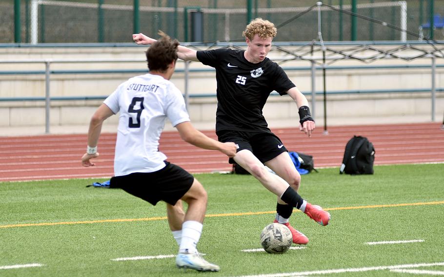 Ramstein striker Joseph Yost looks to dink Stuttgart centerback Christian Groves during a May 3, 2025, match at Ramstein High School on Ramstein Air Base, Germany.